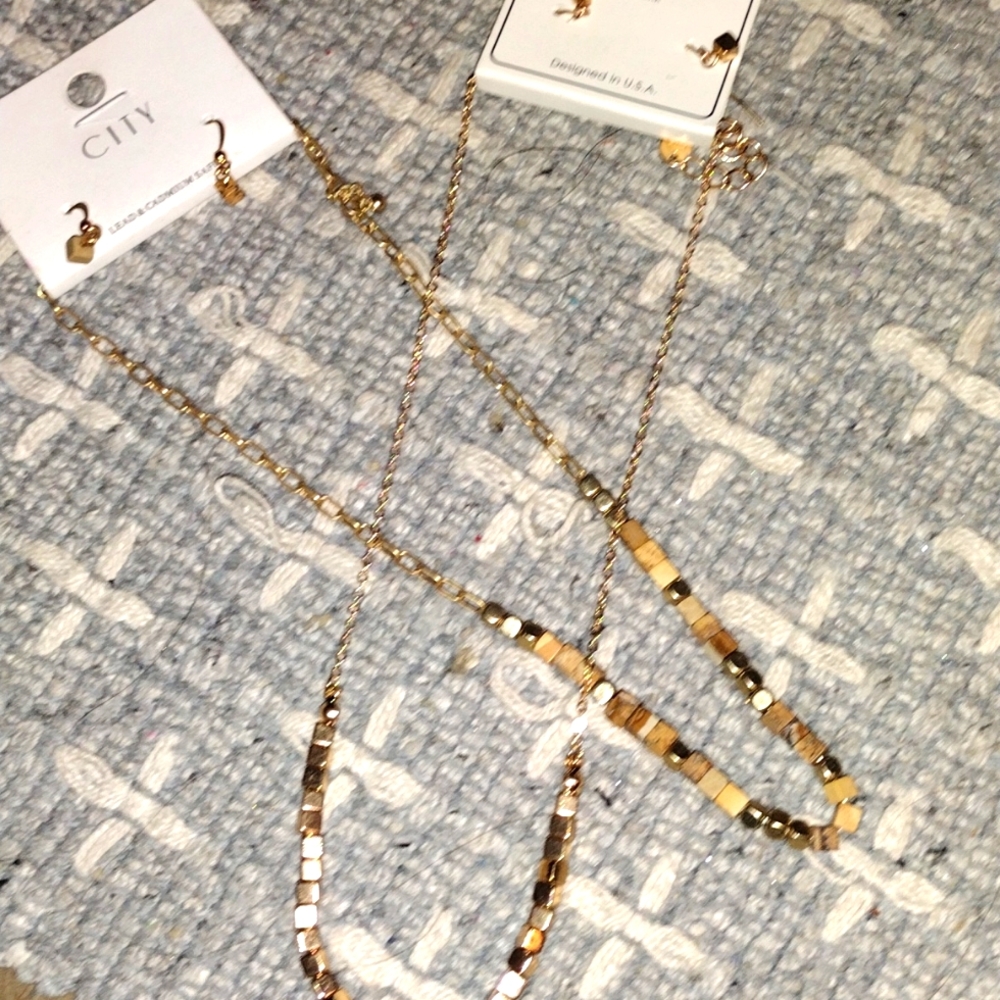 Two woman's necklaces with matching earrings